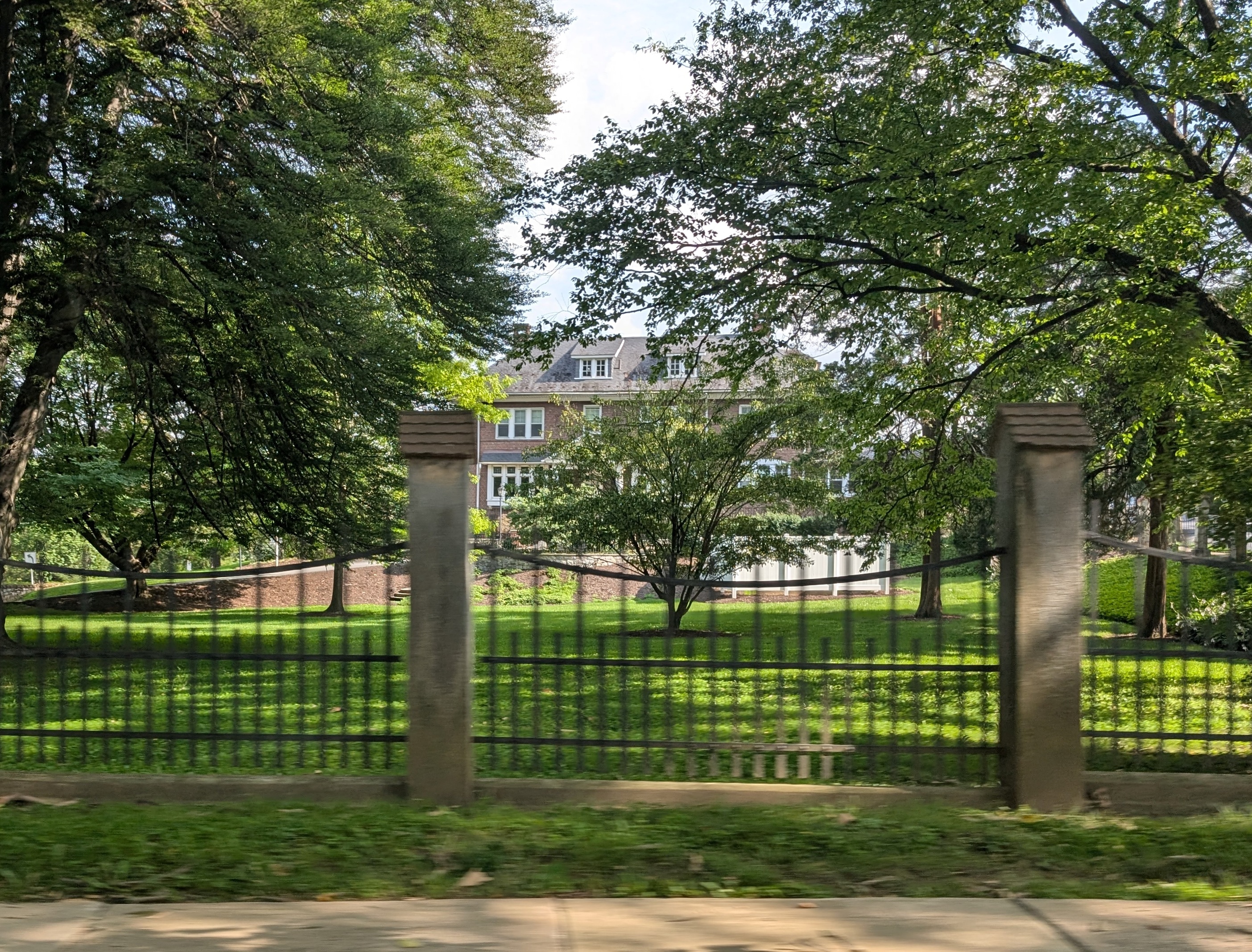 Wyomissing Borough Hall behind the leafy grounds and fence along Penn Avenue